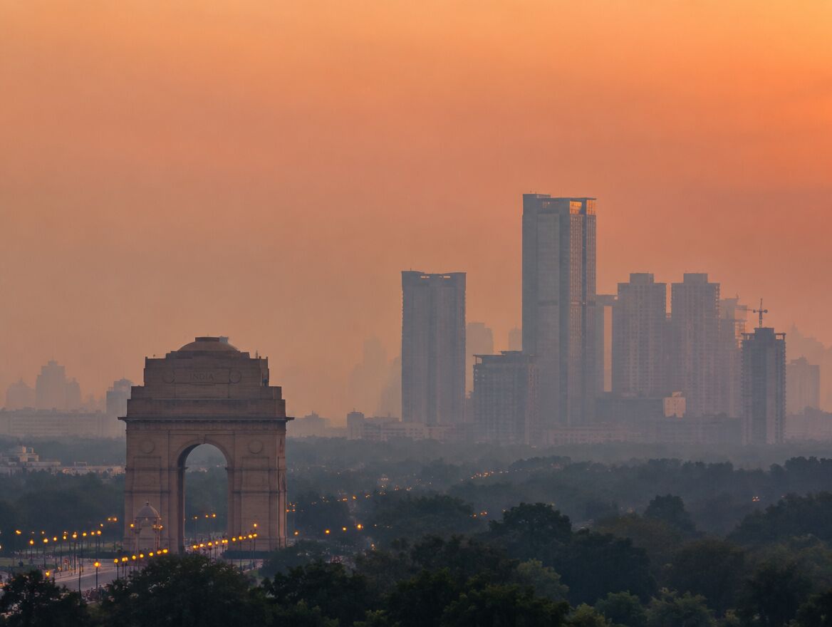 India Gate and the Gurugram skyline at dusk
